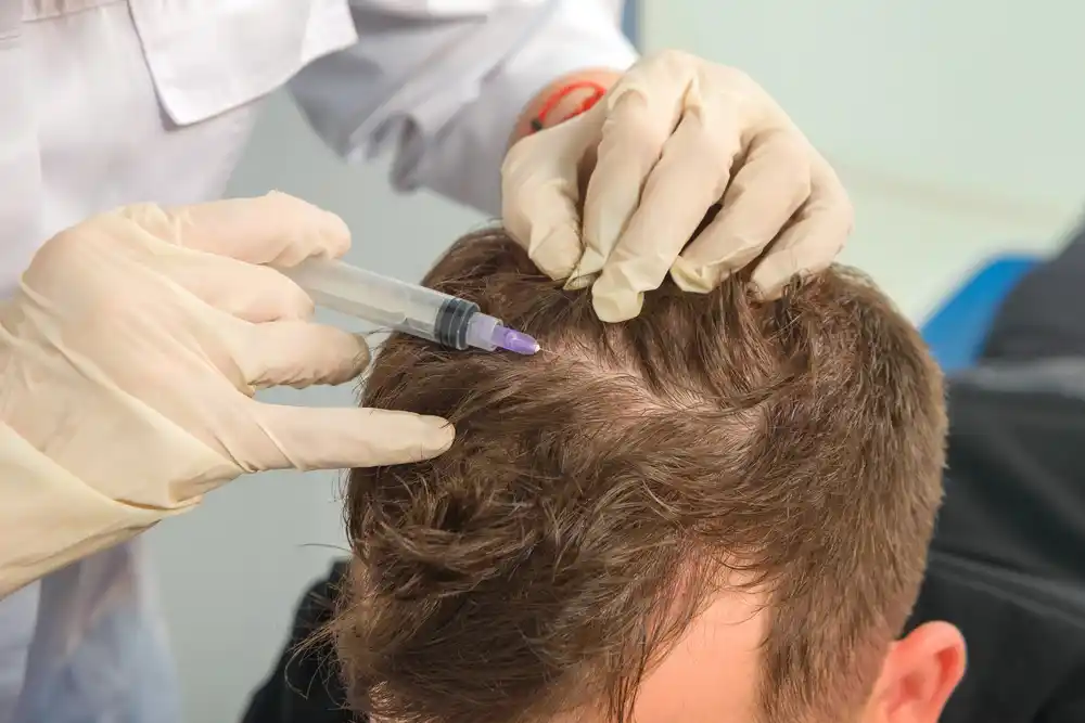 Close up view of physician administering measured micro dosage with fine needle