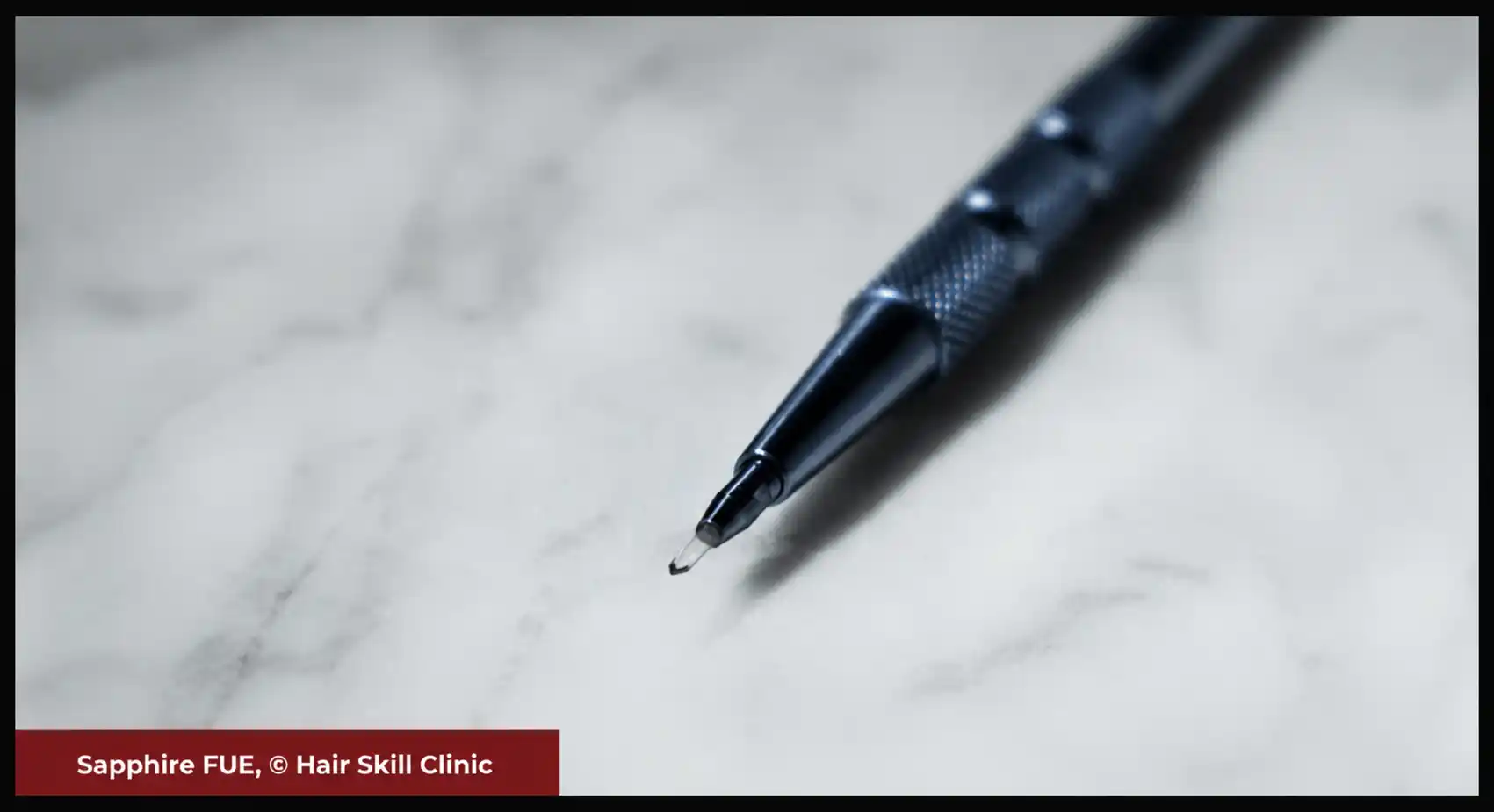 Macro close up view of synthetic sapphire crystal blade scalpel pen tip used for micro channel incisions at Hair Skill Clinic